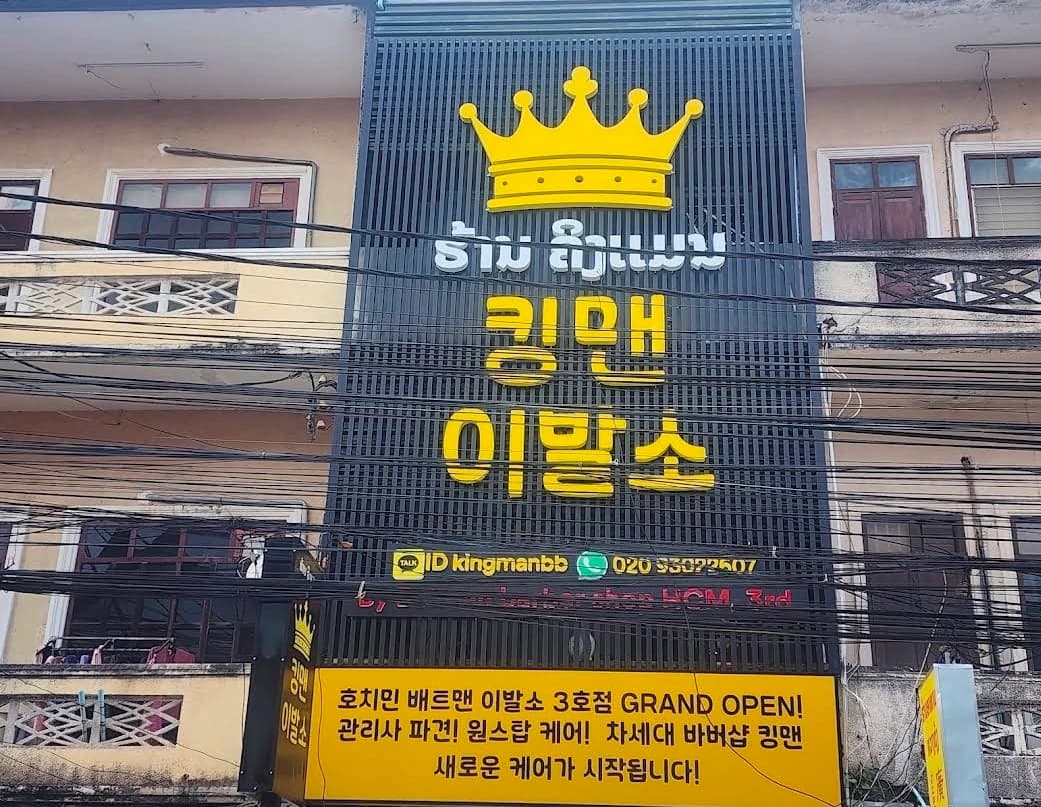 거리에서 올려다본 킹맨이발소 건물 간판