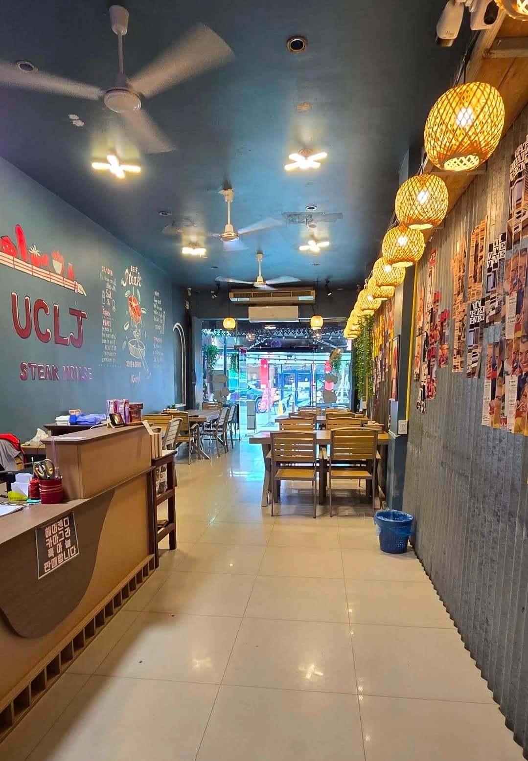 UCLJ STEAK HOUSE 벽화가 있는 Steak Uncle Joe 매장 내부 통로와 좌석
